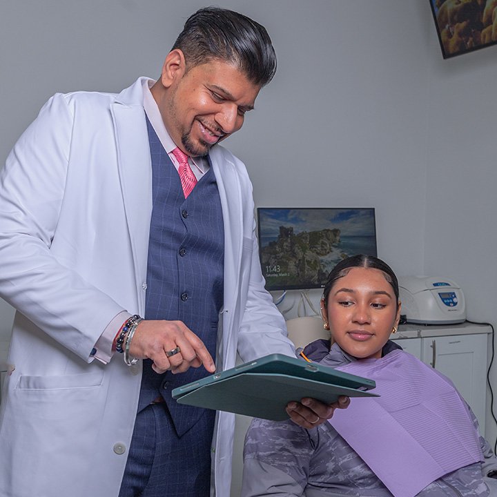 Dr. Sachin Karande providing personalized care to a patient at Karande Dental Care in a modern treatment room
