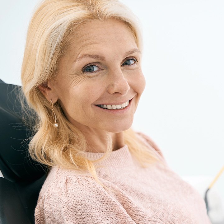Happy senior woman after receiving dental bridges and crowns in Stafford, VA