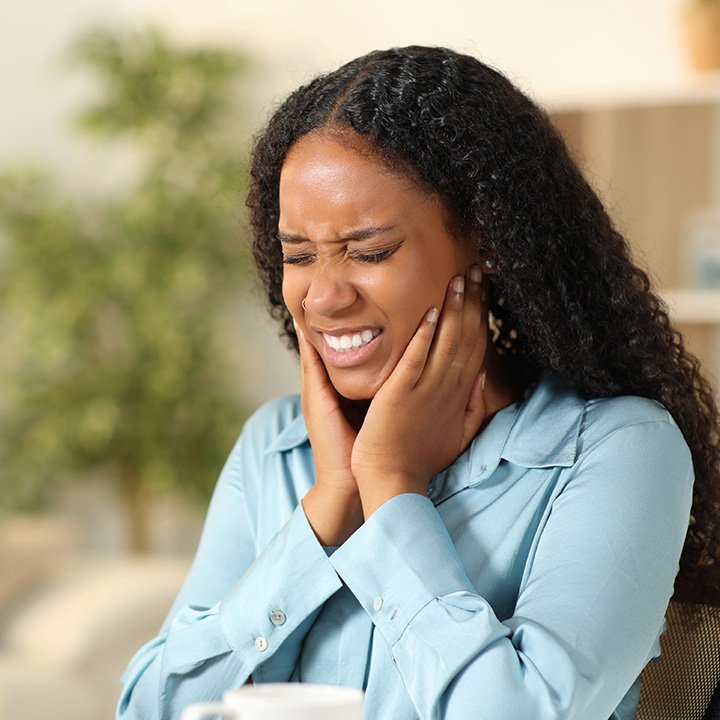 Woman experiencing chronic jaw pain
