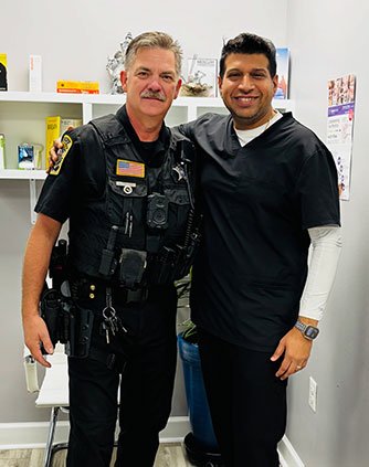 Dr. Sachin Karande with a police officer in Richmond, VA