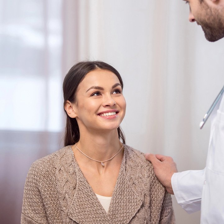 Happy woman after receiving oral cancer screening in Stafford, VA