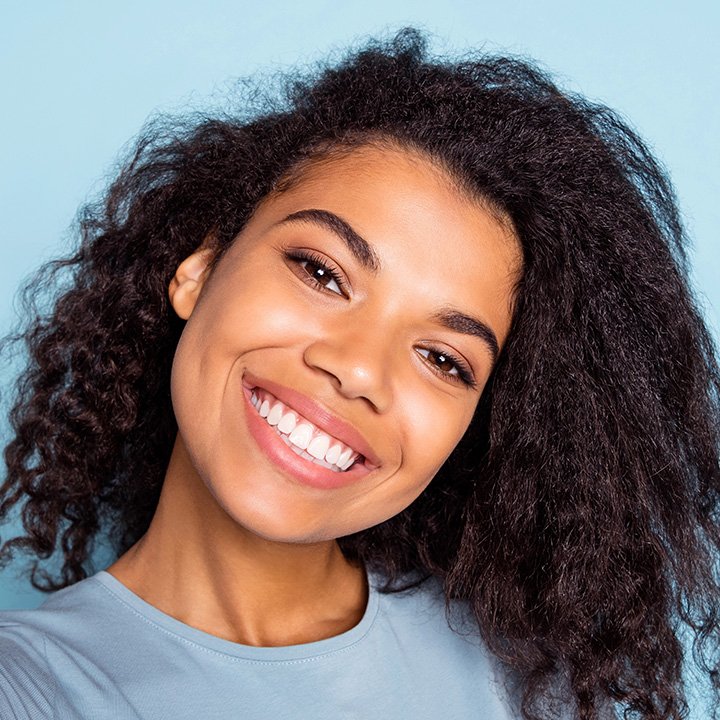 Happy woman taking a selfie after professional teeth cleaning in Stafford, VA