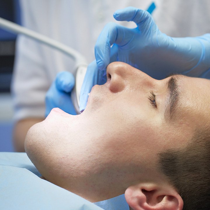 Dentist performing a dental filling procedure on a patient in Stafford, VA