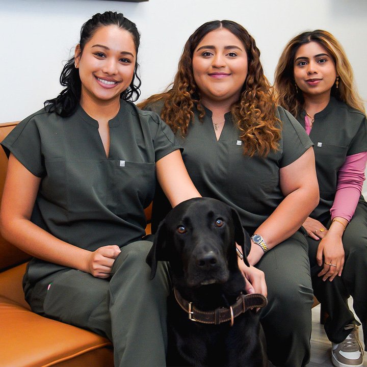 Professional dental team at Karande Dental Care smiling together in front of the clinic, ready to provide exceptional care