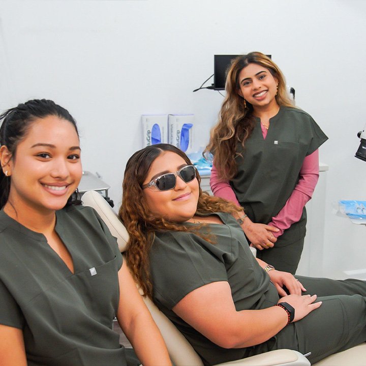 Professional dental team at Karande Dental Care smiling together in front of the clinic, ready to provide exceptional care